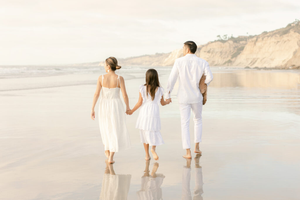 daughter and parents on the beach