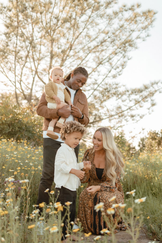 Family photos in wildflowers with parents and children surrounded by spring flowers